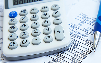 Financial reporting with paper reports and a calculator