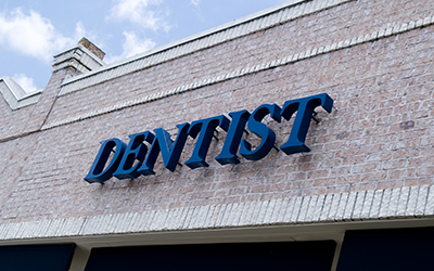 The outside of a building with the word Dentist on it