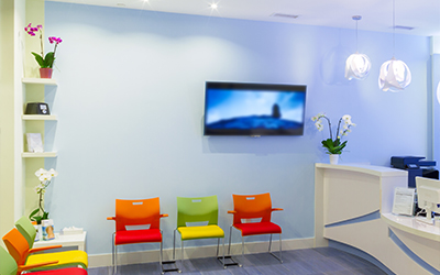 The front desk and waiting area of a dental office