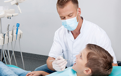Patient in dental chair with doctor